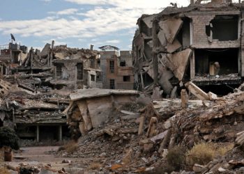 Destroyed buildings are pictured at the Palestinian Yarmuk camp, on the southern outskirts of the Syrian capital Damascus, on November 25, 2020 as families visit the destroyed residential district to inspect their abandoned apartments and register with the authorities with the hope of eventually returning to their homes. - In May 2018, the Syrian government retook the Palestinian camp of Yarmuk and adjacent suburbs after a pulverising assault that lasted nearly a month to expel jihadists who controlled the area for years. That placed the regime in full control of the entire capital for the first time since 2012. Yarmuk is a camp turned into a bustling neighbourhood before the seven-year civil war in Syria, with most of its residents of Palestinian origin. (Photo by LOUAI BESHARA / AFP)