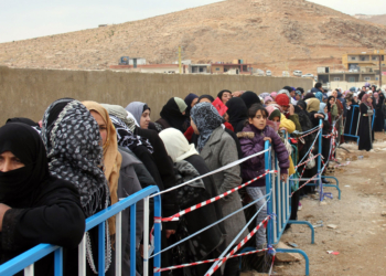 Syrian refugees wait to register upon their arrival in the strategic Lebanese border district town of Arsal on Nov. 18, 2013, after fleeing the fighting in the neighboring Syria. Thousands of Syrian refugees have poured into Lebanon over the past week as fighting between government forces and rebels has flared near the border. AFP PHOTO / STR (Photo credit should read -/AFP/Getty Images)