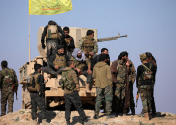 Members of Syrian Democratic Forces (SDF) stand together near Baghouz, Deir Al Zor province, Syria February 12, 2019. Picture taken February 12, 2019. REUTERS/ Rodi Said