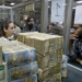 Syrians wait to withdraw money at the Commercial Bank of Syria in Damascus, on November 10, 2022. (Photo by LOUAI BESHARA / AFP)