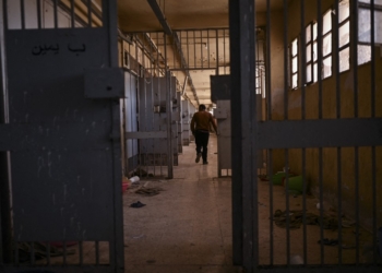 A man walks past empty cells at the Saydnaya prison, north of the Syrian capital Damascus, on December 15, 2024. The dramatic liberation of Saydnaya prisoners came hours after Islamist group Hayat Tahrir al-Sham and allies took the nearby capital on December 8, having sent ousted president Bashar al-Assad fleeing after more than 13 years of civil war. (Photo by Aris MESSINIS / AFP)